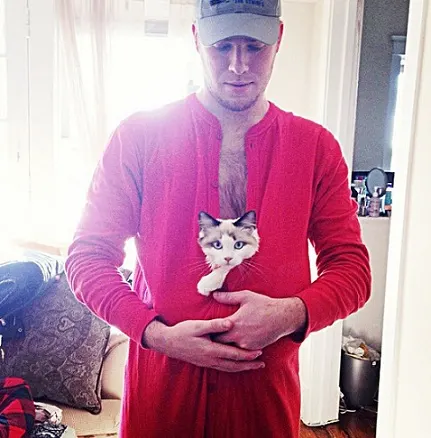 Guy with cat in his onsie