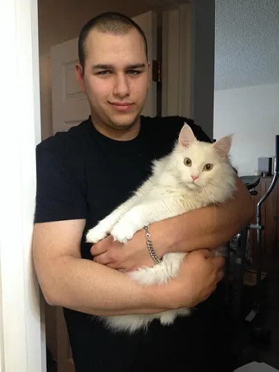 White cat held by man