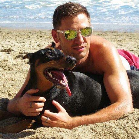 Hot guy and his Doberman at the beach