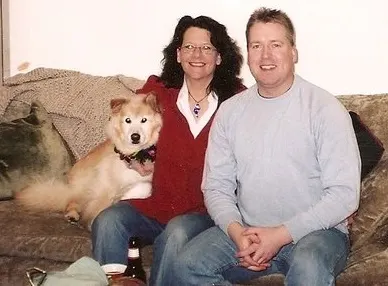 Klyde the husky mix with his owners Pat and Aaron
