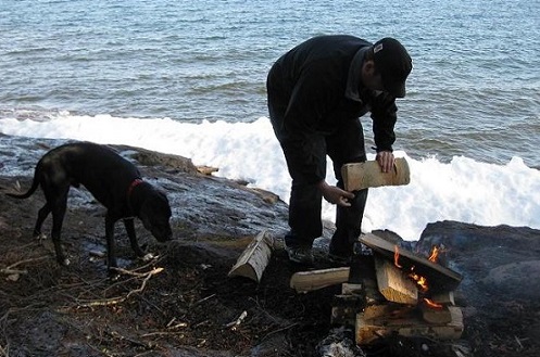 Black Lab by campfire Lake Superior